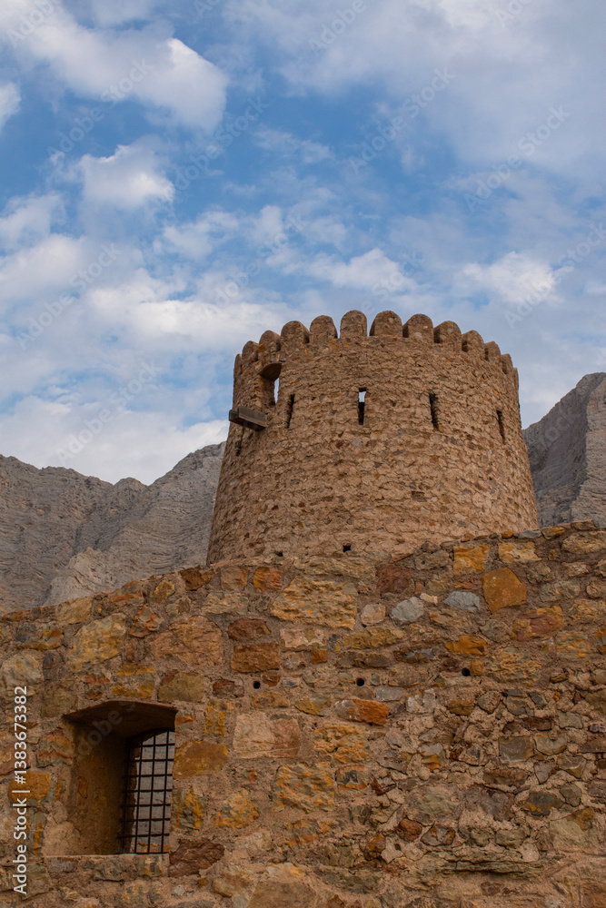 Oman, 03-04-2025: the Al Qala Fort against the mountain in Bukha, a fishing village in the Musandam Peninsula (Ruus Al Jibal), the northeastern point of Arabian Peninsula south of the Strait of Hormuz