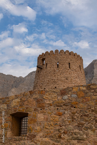 Obraz na płótnie Oman, 03-04-2025: the Al Qala Fort against the mountain in Bukha, a fishing village in the Musandam Peninsula (Ruus Al Jibal), the northeastern point of Arabian Peninsula south of the Strait of Hormuz w salonie