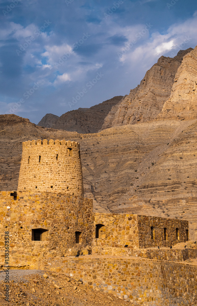 Oman, 03-04-2025: the Al Qala Fort against the mountain in Bukha, a fishing village in the Musandam Peninsula (Ruus Al Jibal), the northeastern point of Arabian Peninsula south of the Strait of Hormuz