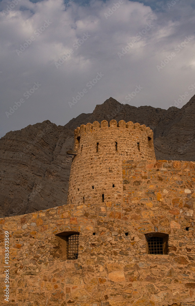 Oman, 03-04-2025: the Al Qala Fort against the mountain in Bukha, a fishing village in the Musandam Peninsula (Ruus Al Jibal), the northeastern point of Arabian Peninsula south of the Strait of Hormuz