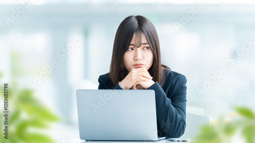 考えごとをする女性・ビジネスウーマン