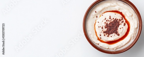 A yogurt and tahini dip with sumac seasoning, earthy tones, isolated on white background