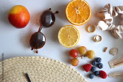 Obraz na płótnie Straw hat, sunglasses, seasonal fruit, seashells and colorful accessories on white backgrounds. Cute summer essentials. Flat lay. w salonie