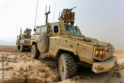 Military Vehicles on Patrol in a Desert Terrain for Security Operations