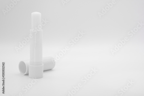 opened stick of lip balm on white background