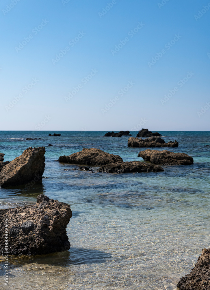 single stones on the sandy coast of the Mediterranean Sea on the island of Crete