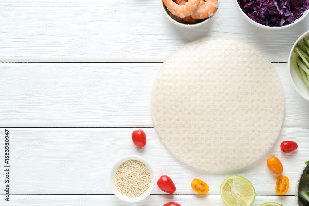 Rice paper sheets and different ingredients on white wooden table, flat lay. Space for text Rice paper sheets and different ingredients on white wooden table, flat lay. Space for text