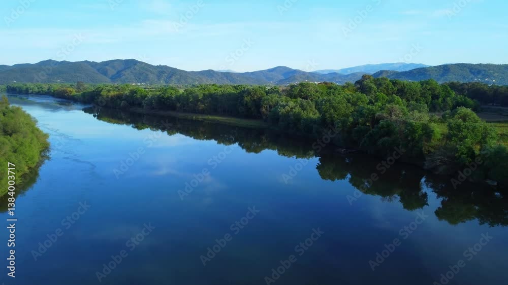 vertical top down view on a river with forests, drone flight, Beautiful Aerial View of African Jungles forest and River, Eastern Algeria, Reflection in the Blue Lake, Vacation time with boat trip. vertical top down view on a river with forests, drone flight, Beautiful Aerial View of African Jungles forest and River, Eastern Algeria, Reflection in the Blue Lake, Vacation time with boat trip.