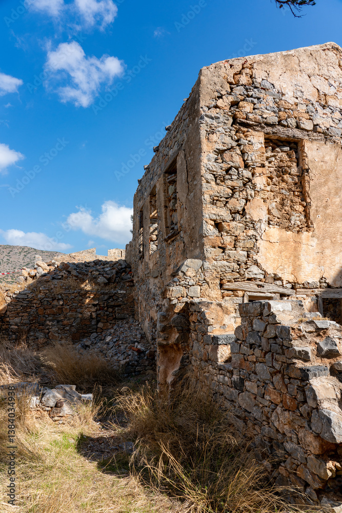 Fototapeta premium Crumbling Stone Ruins Amid Dry Overgrowth