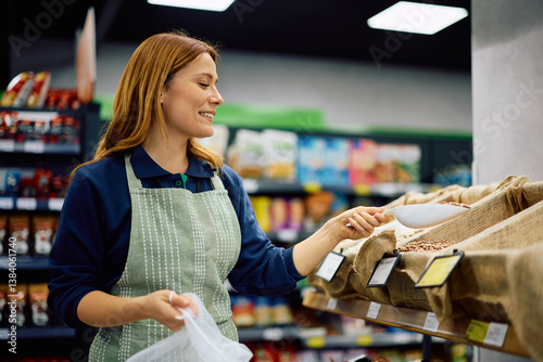 Bild auf Leinwand Happy female vendor at organic food section.