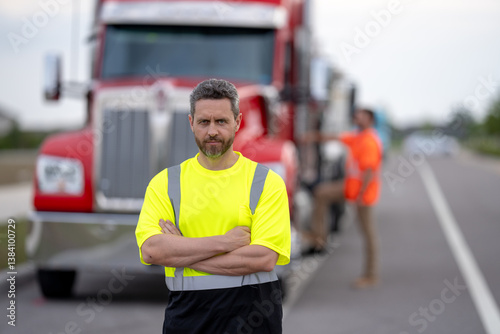 Portrait of happy truck driver looking at camera. Truck Drivers Checking the Truck's Safety Maintenance Checklist. Inspection Safety of Semi Truck Wheels Tires. Mechanic Auto Service Shop.