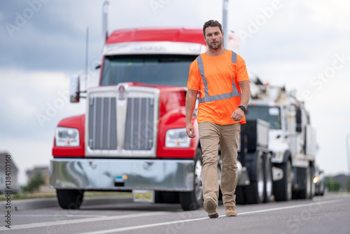 Portrait of happy truck driver looking at camera. Truck Drivers Checking the Truck's Safety Maintenance Checklist. Inspection Safety of Semi Truck Wheels Tires. Mechanic Auto Service Shop.
