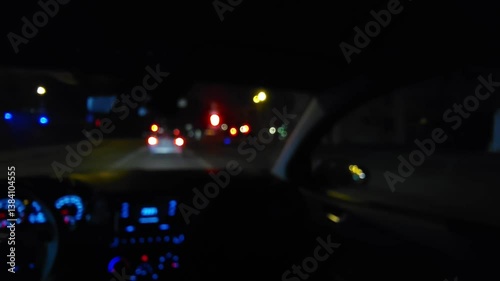Night drive on urban highway - POV view from moving car through windshield at night