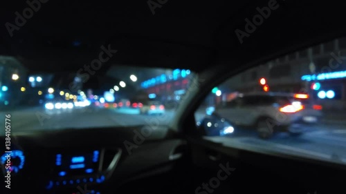 Night drive on urban highway - POV view from moving car through windshield at night