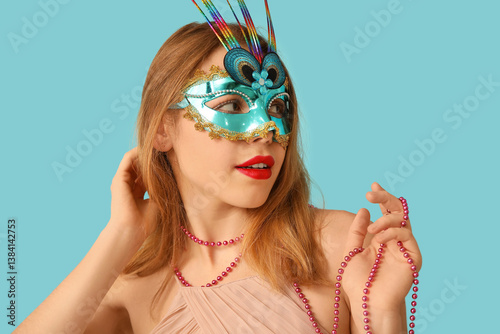 Young woman wearing teal ve...