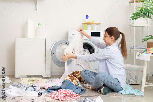 Young woman loading dirty l...