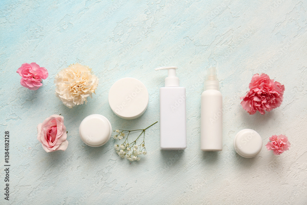 Different cosmetics and beautiful flowers on light background Different cosmetics and beautiful flowers on light background
