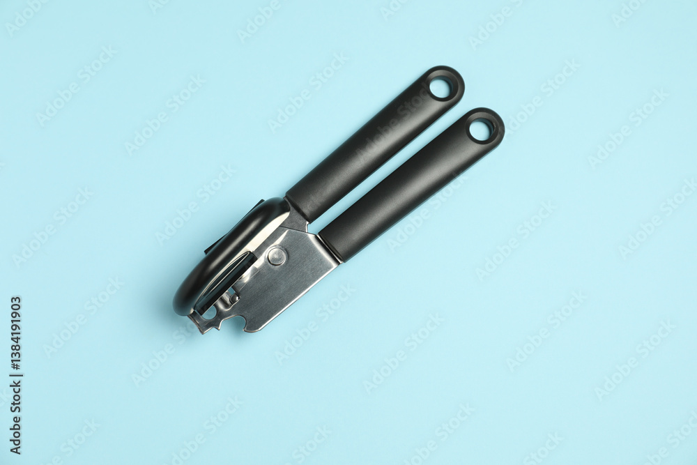 One can opener on light blue background, top view One can opener on light blue background, top view