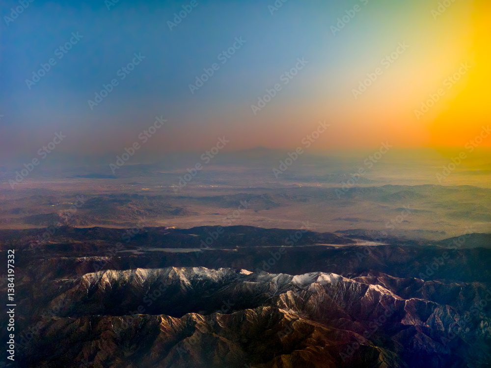 High altitude view of mountain region with snow and dramatic sky