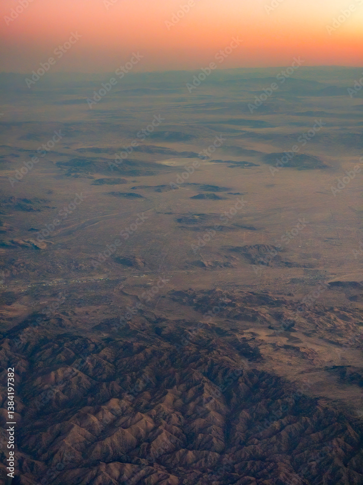 High altitude aerial view of landscape mountains and dramatic sky