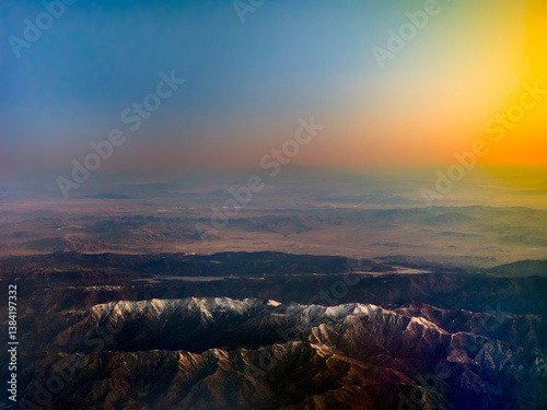 Obraz na płótnie High altitude view of mountain region with snow and dramatic sky w salonie