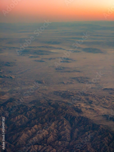 Obraz na płótnie High altitude aerial view of landscape mountains and dramatic sky w salonie