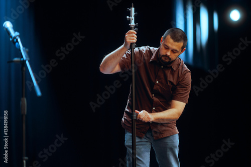 Fotografie Technician Adjusts and Arranges a Microphone on Stage