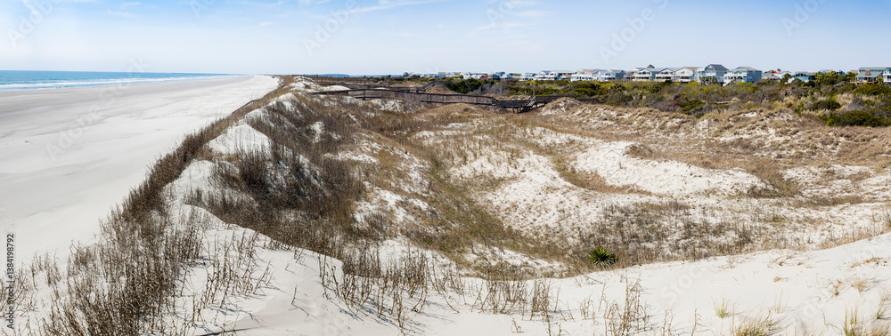 Panoramic style photograph of classic Eastern Coast beach with features including pier and homes