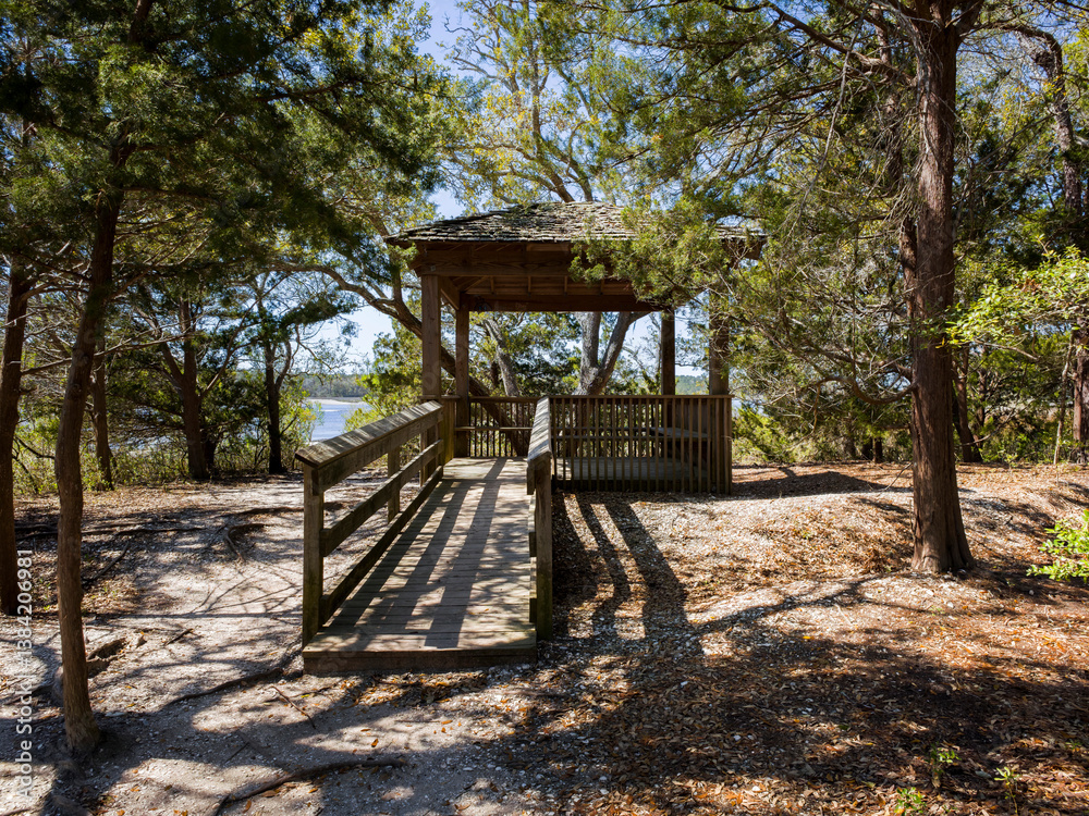 Seat and covered structure nestled in a deep wooded forest setting in a Southeastern setting of the US