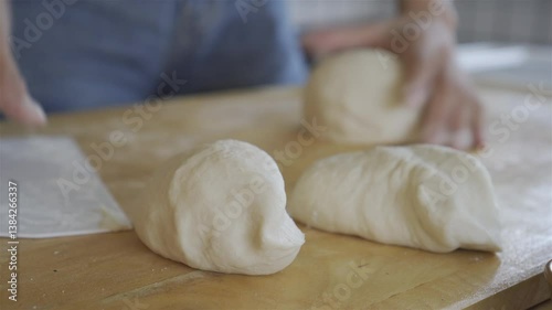 woman's hands using a dough cutter to divide dough