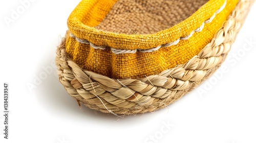 Close-up of a yellow woven fabric loafer with braided rope detailing around the sole. Focus on the textured materials and craftsmanship.