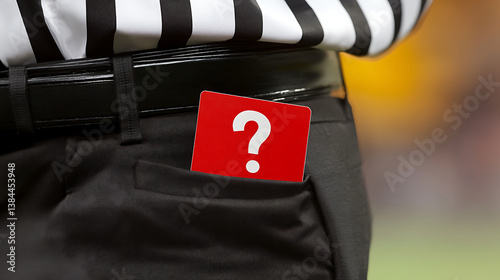 Close Up Of A Referee Presenting Red Card For Foul In A Football Match Against Blurred Green Field Background photo