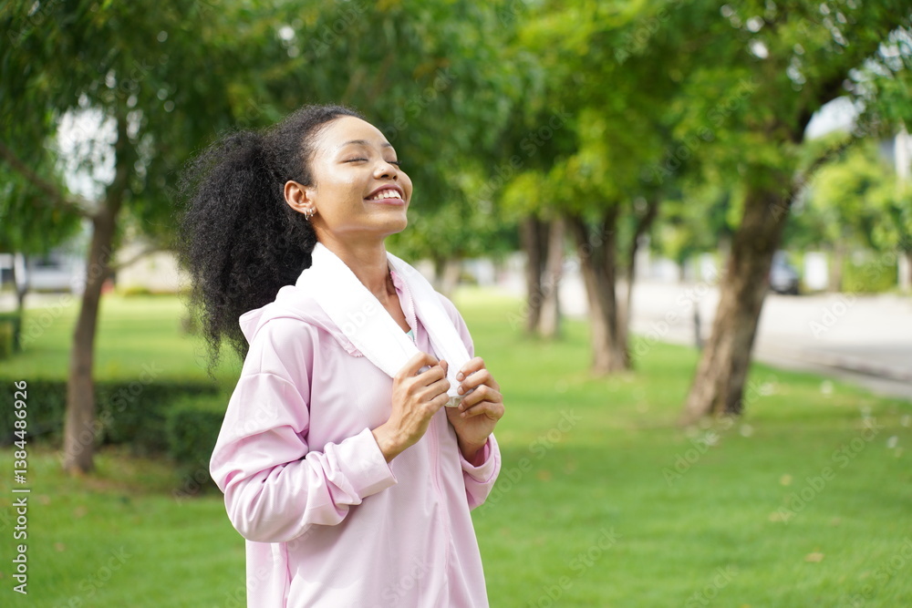 woman breathing deeply with closed eyes and smiling after finishing outdoor workout in park woman breathing deeply with closed eyes and smiling after finishing outdoor workout in park