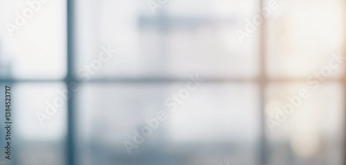 Blurry image depicting an out of focus view through an office window, suggesting a modern and professional setting.