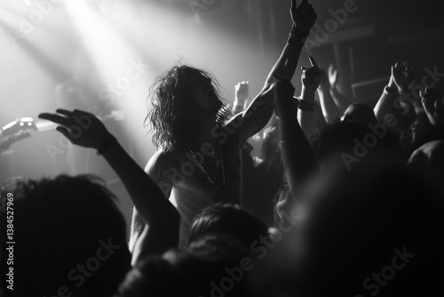 black and white photo of crowd hands up. Live stage performance at rock show concert. Hands of people at a concert. Live music awards
