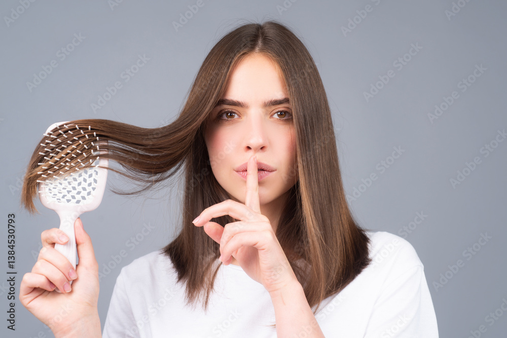 Girl combing hair. Beautiful secret young woman holding comb straightened hair. Attractive smiling woman portrait with comb.