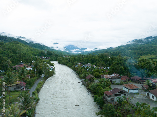 Aerial view of a river crossing a remote village in Indonesia