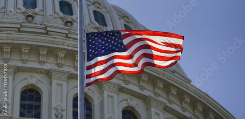 Foto The flag of the United States waves over the Capitol dome