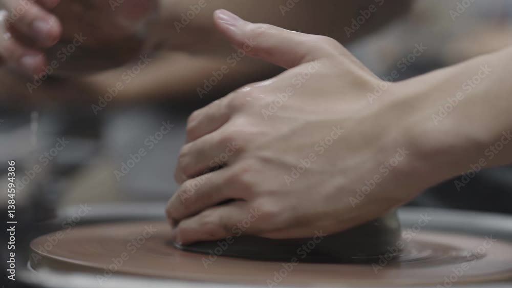 Close-up of hands shaping a clay vase on a pottery wheel, showcasing traditional Thai craftsmanship. Close-up of hands shaping a clay vase on a pottery wheel, showcasing traditional Thai craftsmanship.