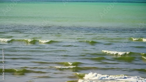 Tropical green ocean water off the coast of an island on a bright sunny day