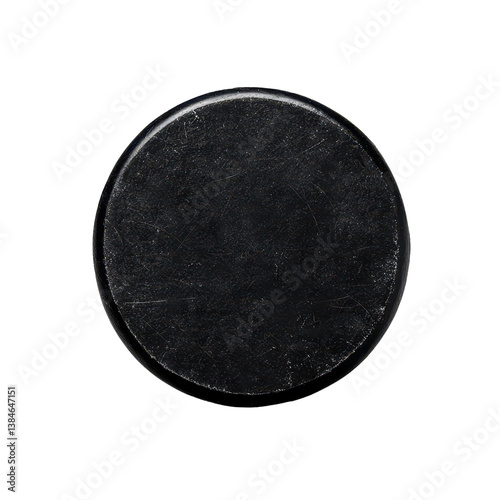 Black hockey puck ready for action on the ice surface isolated against a transparent background.