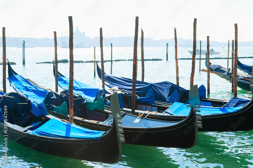 Gondolas on the Grand canal at foggy morning in Venice, Italy.
