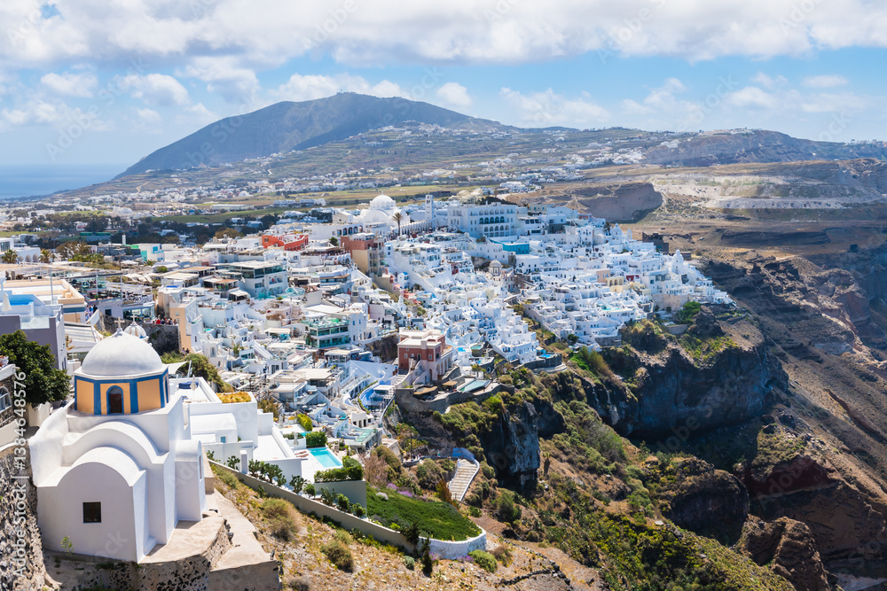 White architecture in Santorini island, Greece. Panoramic view of Fira town at sunny day.