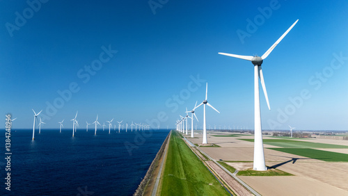 offshore windmill park features numerous wind turbines generating clean energy along the Dutch coastline. Offshore windmill turbines in the ocean green energy transition in the Netherlands