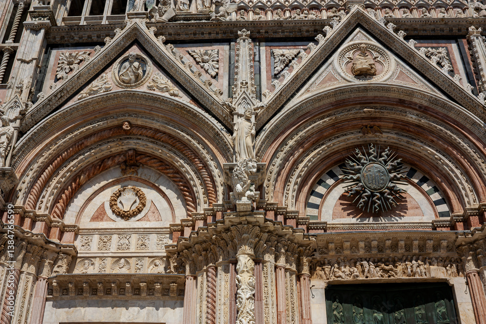 Fototapeta premium Close up of the pediments of two gothic gates 