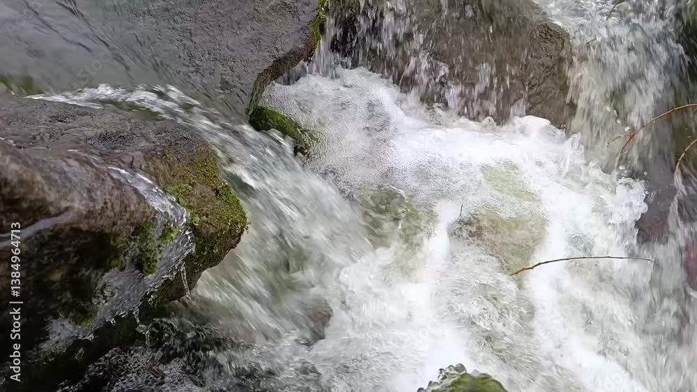 A small waterfall in the middle of a rocky area A small waterfall in the middle of a rocky area
