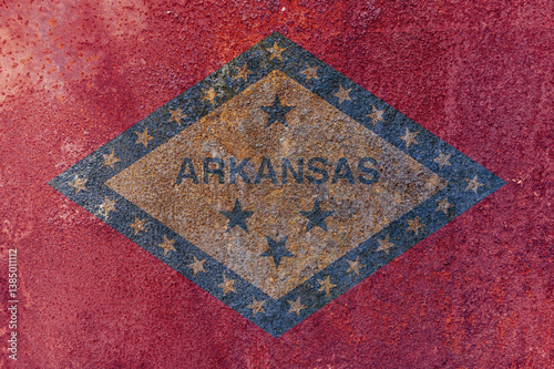 Arkansas State Flag. Dirty Arkansas state flag on rusty metal surface. photo