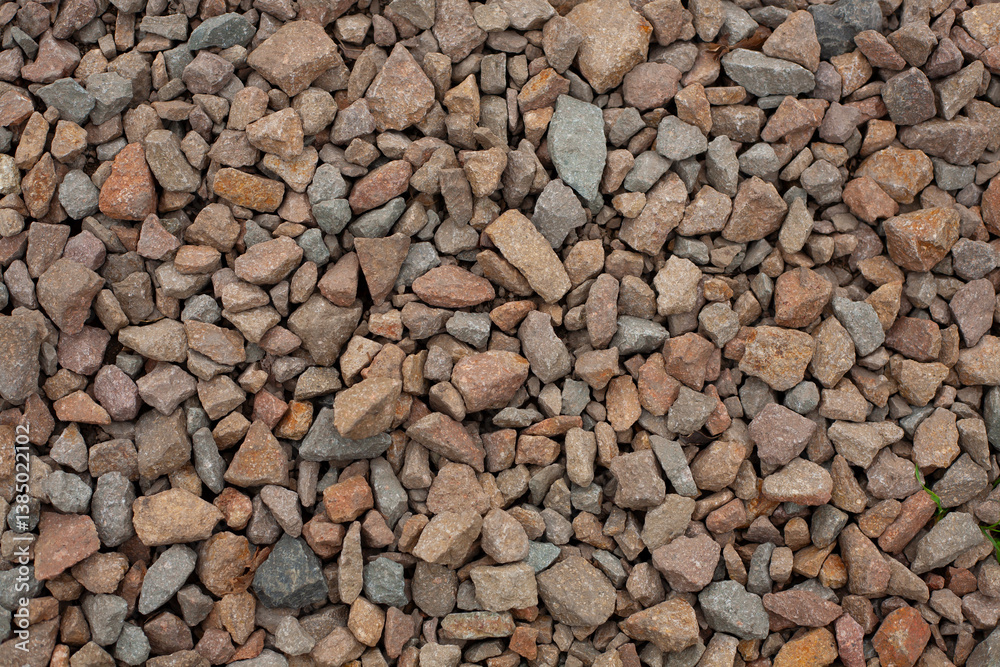 Close-up of porphyry aggregate, construction crushed stone. Natural building material, suitable for road construction, landscaping, and concrete production Close-up of porphyry aggregate, construction crushed stone. Natural building material, suitable for road construction, landscaping, and concrete production