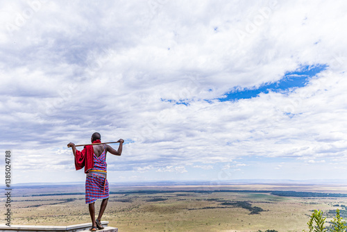 Maasai Man standing on the edge of the landscapes of the  Maasai Mara National Game Reserve Angama Mara Kenya People Cultural Traditional Heritage Festival Great Rift Valley Province Narok County Sava