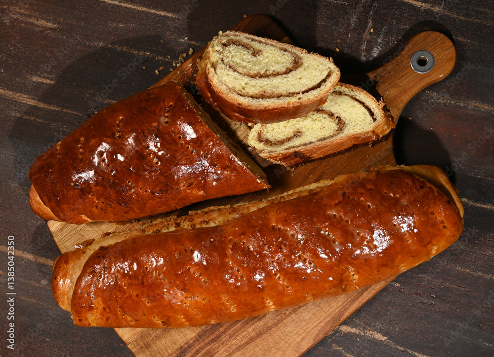 Freshly baked sweet bread with a golden crust and cinnamon swirl on a wooden cutting board
